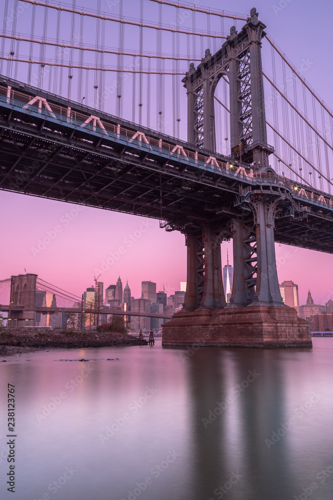 View on Manhattan Bridge and financial district from east river ,with long exposure View on Manhattan Bridge and financial district from east river ,with long exposure