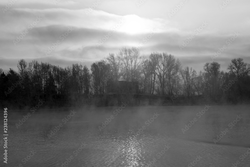 Winter landscape. The ice on the river. The mist over the water. Low air temperature.