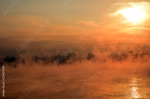 Fototapeta Naklejka Na Ścianę i Meble -  Beautiful sunset over the sea. The mist over the river. Low air temperature.
