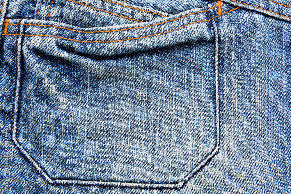 Denim fabric texture with yellow stitching Denim fabric texture with yellow stitching