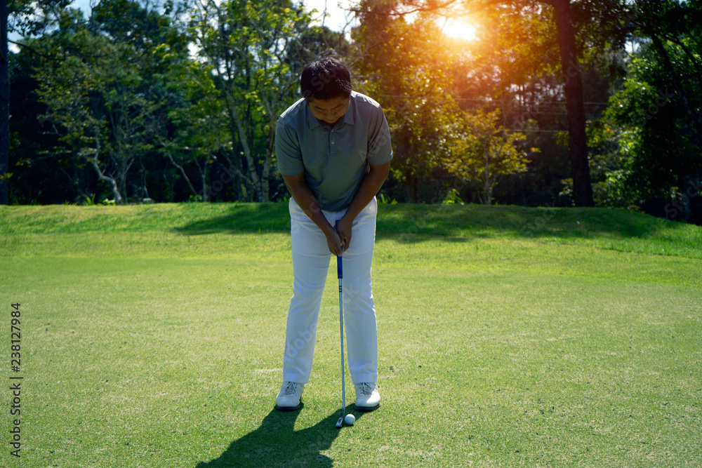 Golfer playing golf in beautiful golf course in the evening golf course with sunshine in thailand