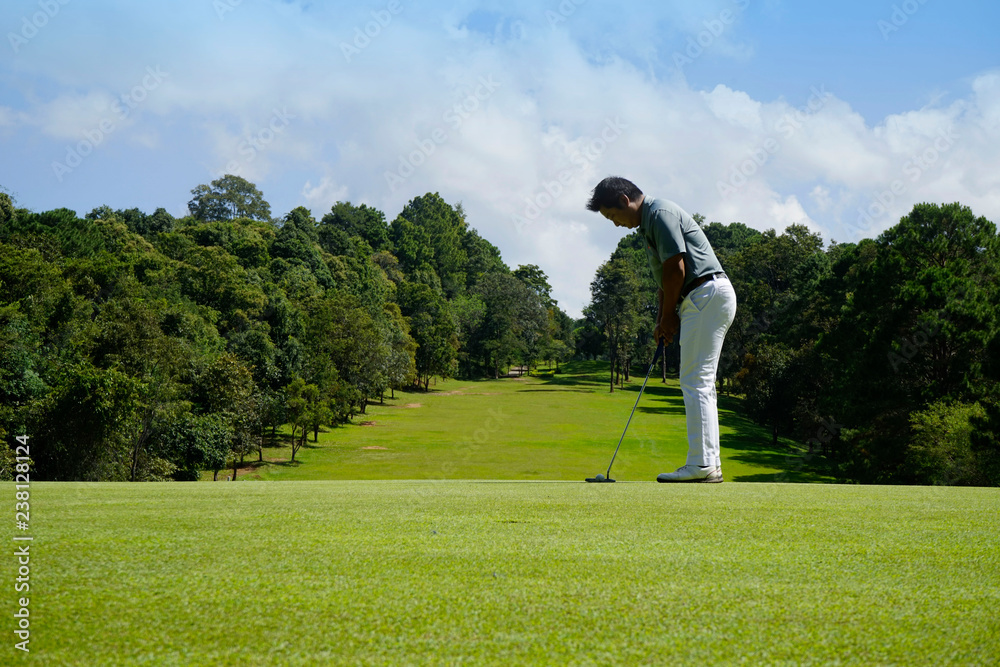 Golfer playing golf in beautiful golf course in the evening golf course with sunshine in thailand Golfer playing golf in beautiful golf course in the evening golf course with sunshine in thailand
