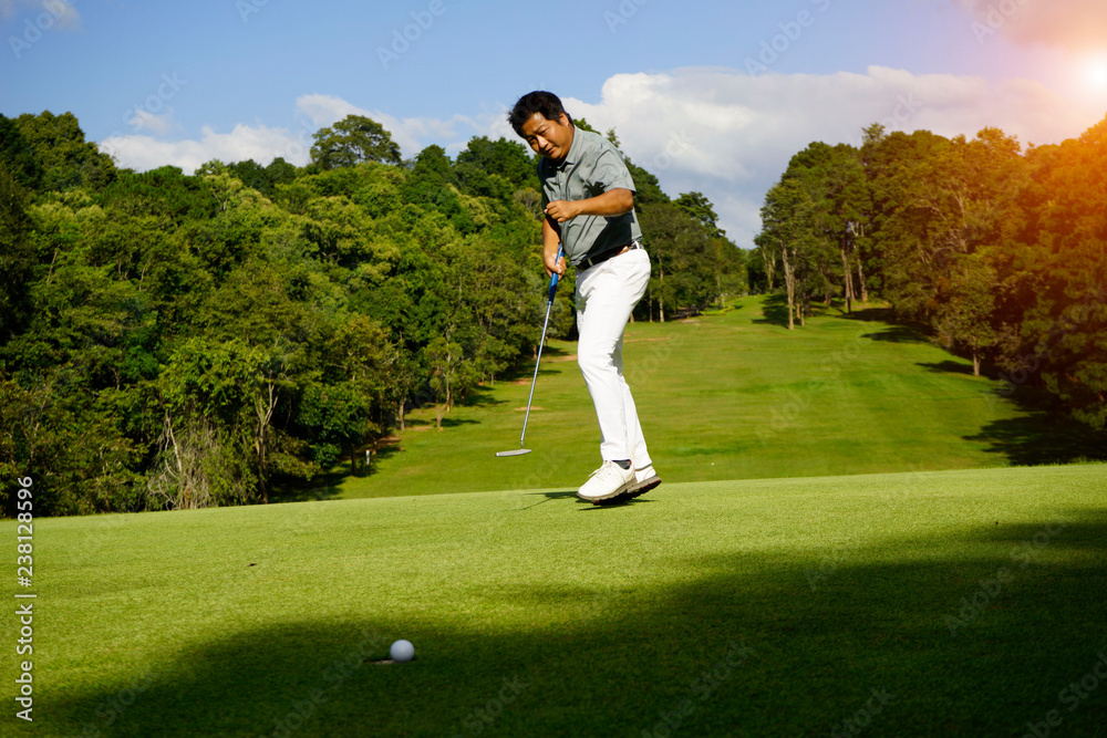 Fototapeta premium Golfer playing golf in beautiful golf course in the evening golf course with sunshine in thailand