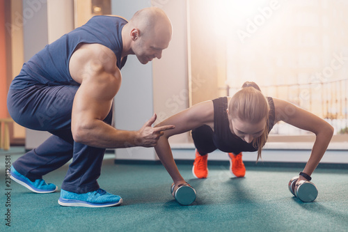 The girl is wrung out on dumbbells control rainer photo