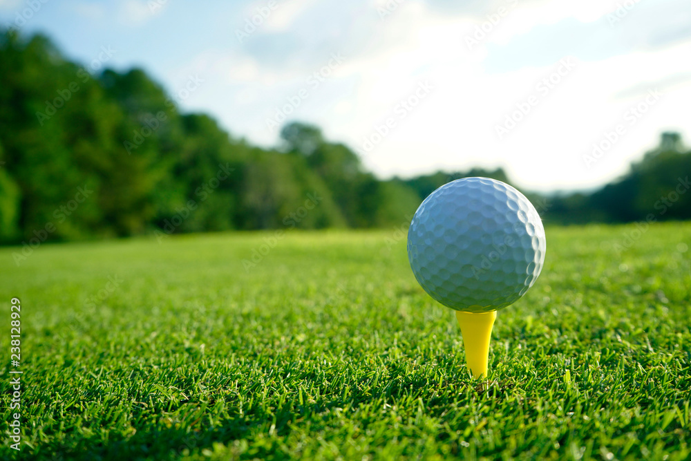 Golf ball on tee in beautiful golf course at sunset background. Golf ball on tee in beautiful golf course at sunset background.