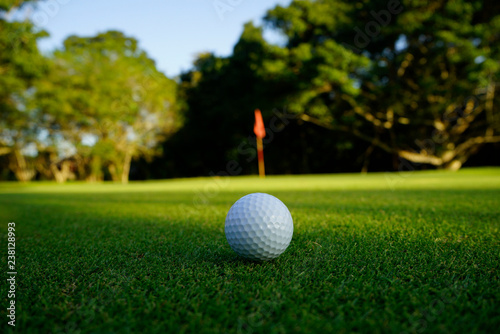Golf ball on green in beautiful golf course at sunset background. Golf ball on green in golf course at Thailand