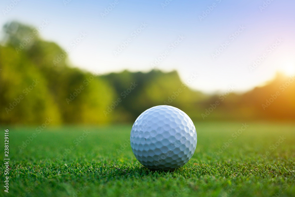 Golf ball on green in beautiful golf course at sunset background. Golf ball on green in golf course at Thailand Golf ball on green in beautiful golf course at sunset background. Golf ball on green in golf course at Thailand