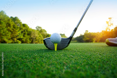 Golf ball and golf club in beautiful golf course at Thailand. Collection of golf equipment resting on green grass with green background