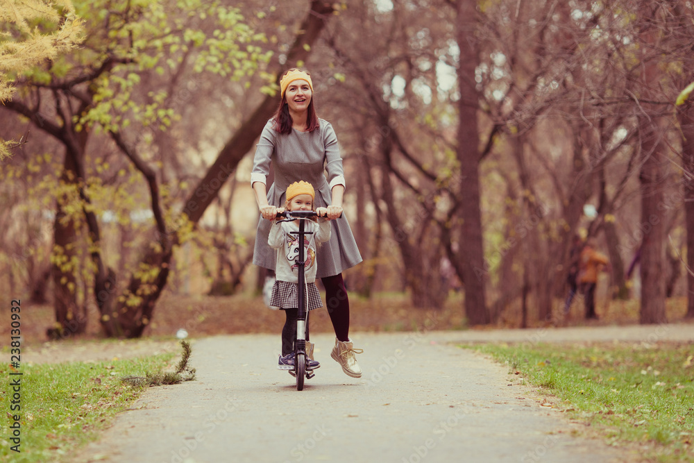 beautiful girl and mother in knitted crown walk in autumn park beautiful girl and mother in knitted crown walk in autumn park