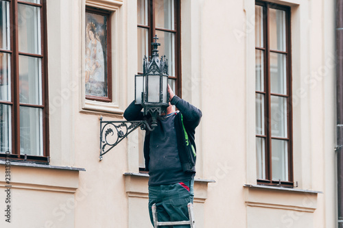 electrician repairing a streetlamp © jon_chica