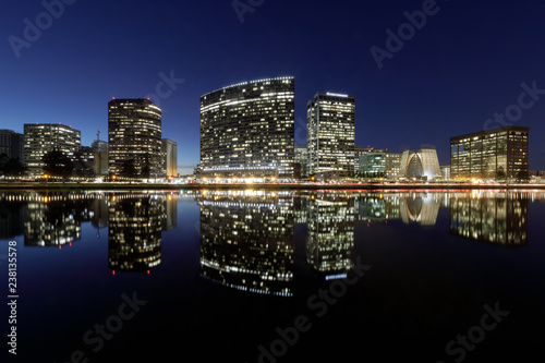 Oakland skyline panoramic view with Lake Merritt Reflections at blue hours. Oakland, Alameda County, California, USA.