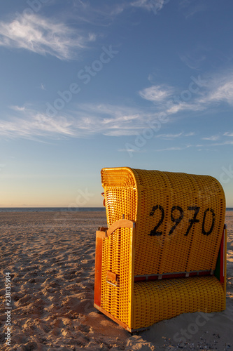 Beach chair on the East Frisian Island Juist in the North Sea, Germany, in evening light before sunset. © DirkR