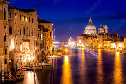Basilica Santa Maria della Salute, Punta della Dogona and Grand Canal at blue hour sunset in Venice, Italy with reflections