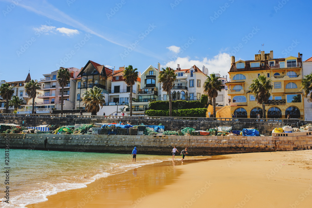 CASCAIS, PORTUGAL - MARCH 26, 2018: A beautiful view of famous Cascais old city center, beach and tourists CASCAIS, PORTUGAL - MARCH 26, 2018: A beautiful view of famous Cascais old city center, beach and tourists