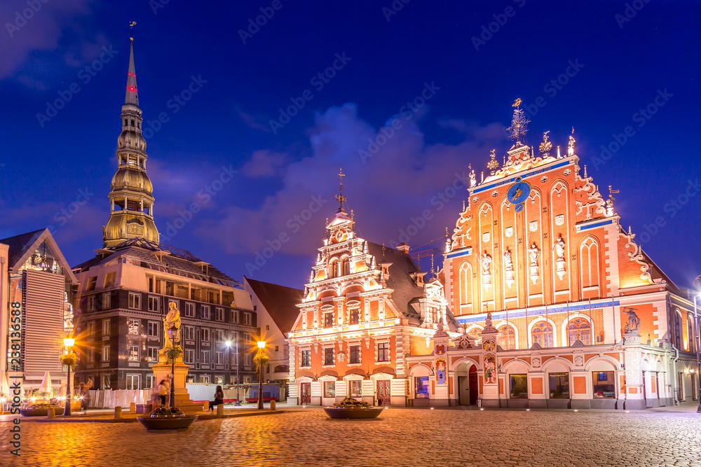 Panorama of Riga Old Town Hall Square, Roland Statue, The Blackheads House and St Peters Cathedral illuminated in the twilight, Riga, Latvia