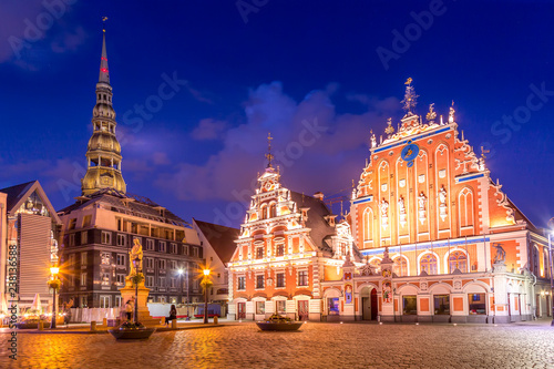 Panorama of Riga Old Town Hall Square, Roland Statue, The Blackheads House and St Peters Cathedral illuminated in the twilight, Riga, Latvia
