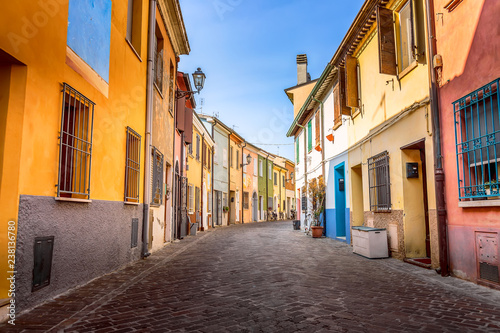 Narrow street of the village of fishermen San Guiliano with colorful houses and bicycles in early morning in Rimini, Italy.