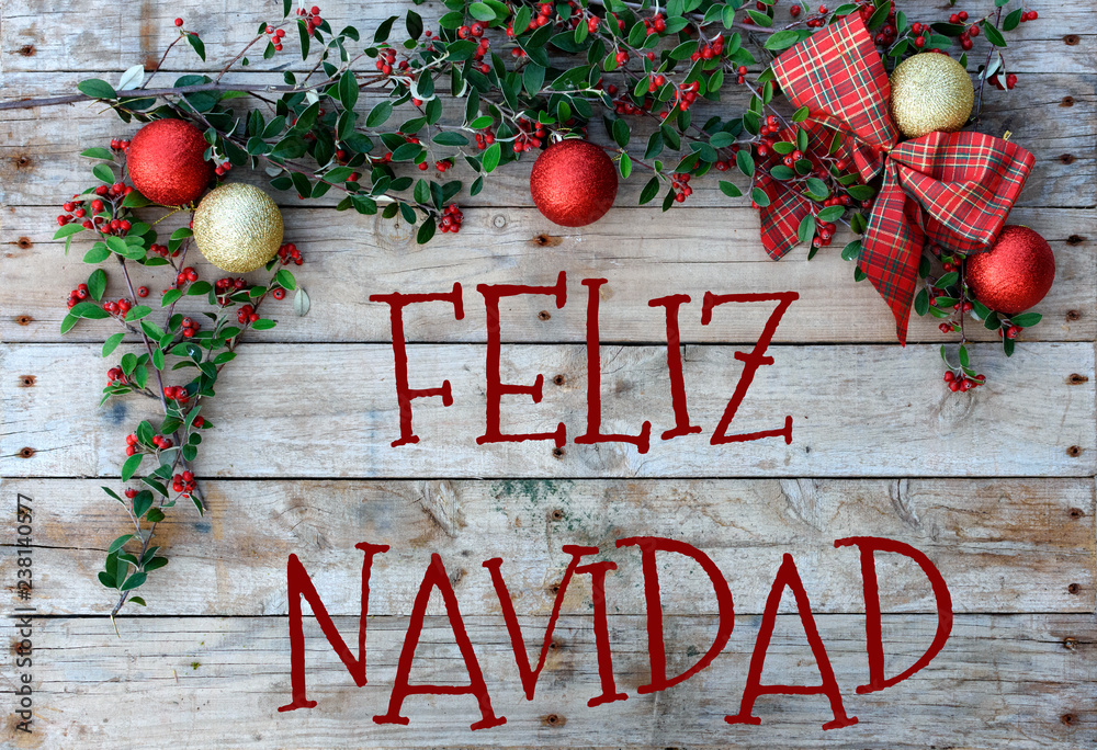 Christmas postcard for greetings. “Feliz Navidad” on natural wooden