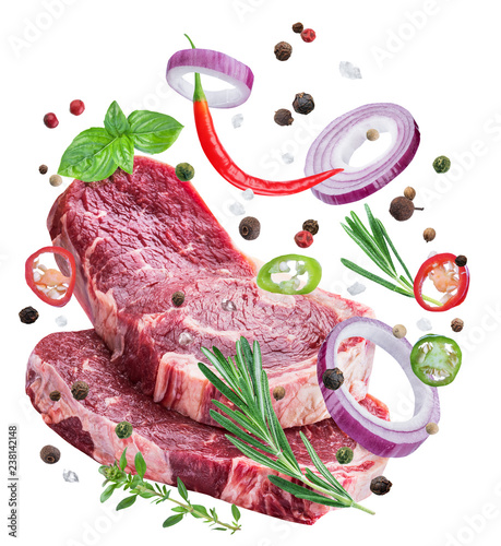 Falling down meat steaks and spices. Flying motion effect of cooking process.