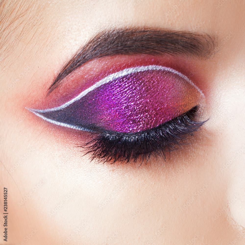 Amazing Bright eye makeup. Eye shadow with a purple tint and an unusual Stock Photo | Adobe Stock