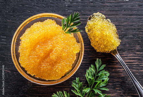 Fotografie Pike caviar or roe in the bowl on wooden background.
