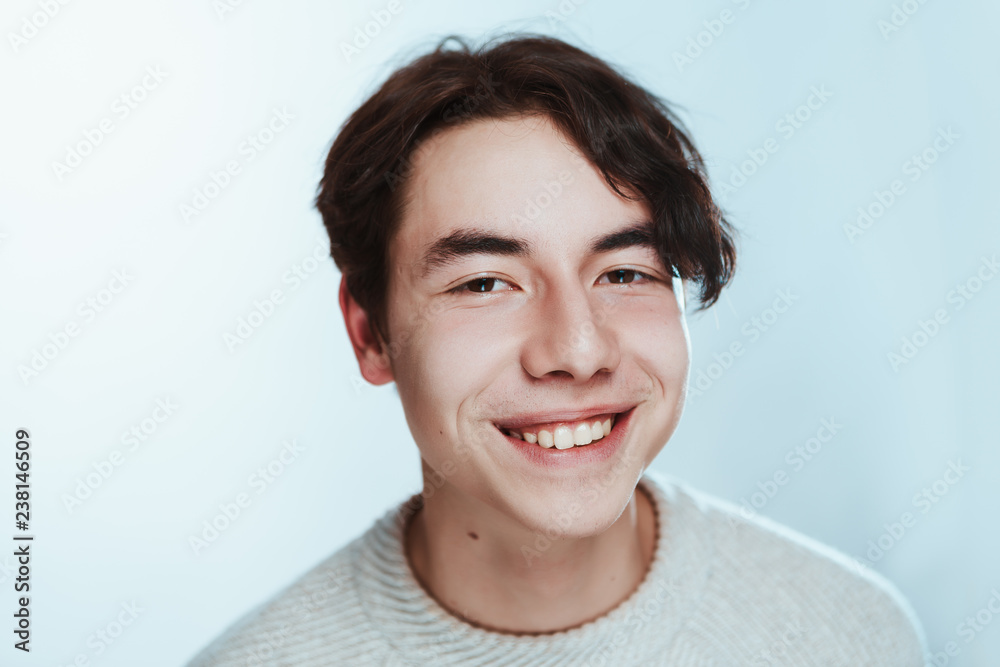 portrait of a teenager brunette guy in a studio portrait of a teenager brunette guy in a studio