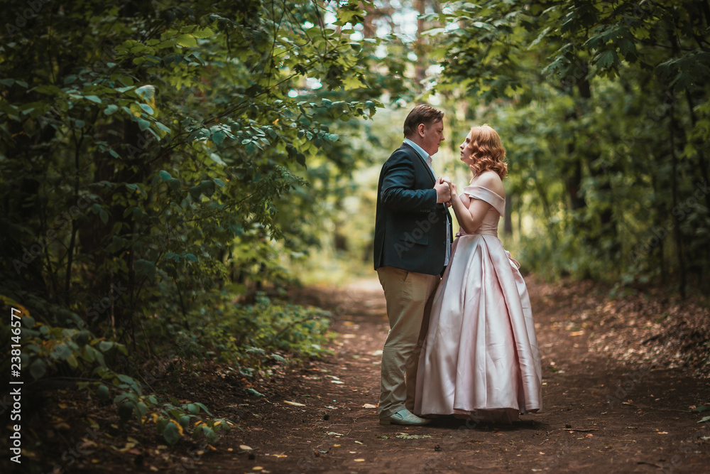 bride and groom dancing in the forest background and sunlight bride and groom dancing in the forest background and sunlight