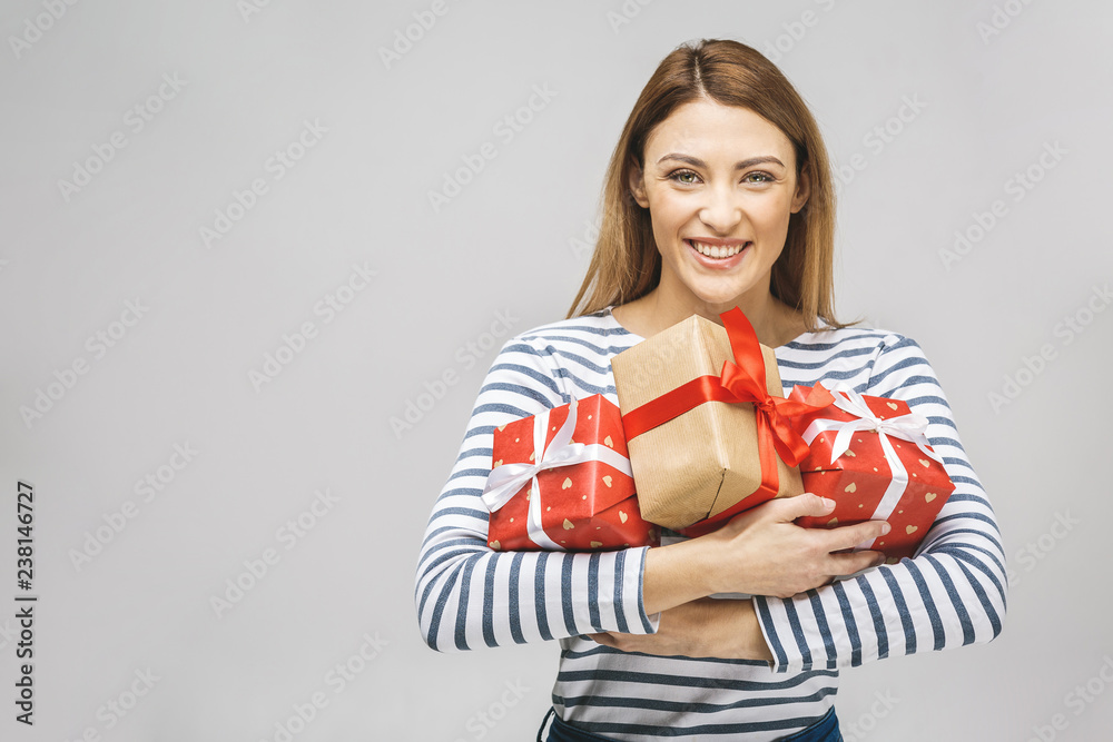 Nice surprise! Happy brunette woman holding big pile of gifts. Isolated over white background. Nice surprise! Happy brunette woman holding big pile of gifts. Isolated over white background.