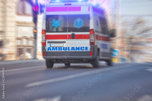 Paramedic 911 ambulance car running fast through the big city.