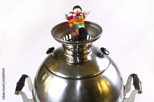 Samovar, Russian national souvenir and Russian folk ritual doll on a white background