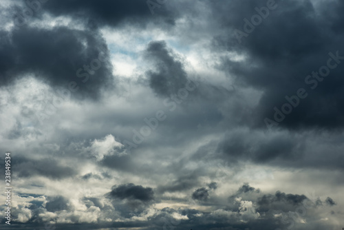 Beautiful grey Fluffy Rain Clouds. Cloudscape after bad weather. Autumn dark Storm Clouds over Black Sky.