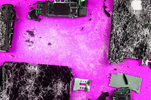 shattered, broken smartphone on colored background