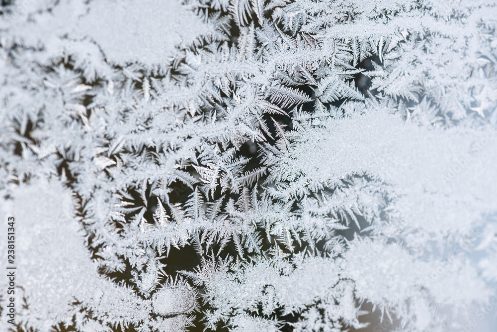 Frosty natural pattern at a winter window glass. Copy space.