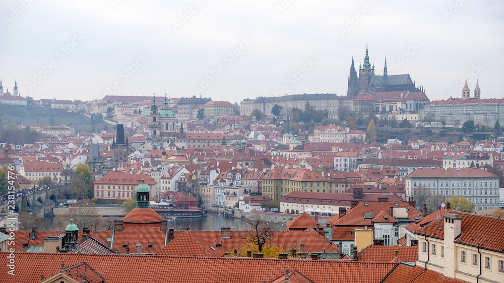 Prague castle view from astronomical tower, top view of Prague city with layer of red roof.