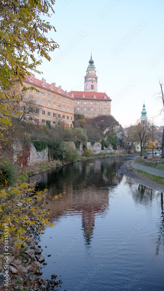 cesky krumlov castle tower with refection on vltava river in autumn