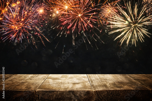 Empty wooden table in front of fireworks background. Product display montage.
