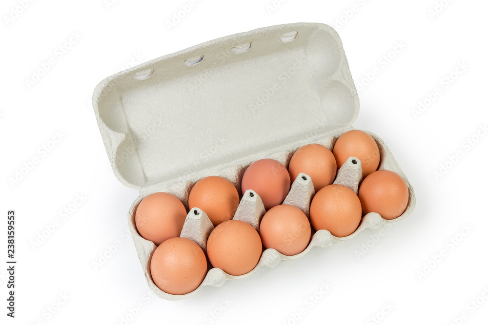 Brown eggs in paper pulp egg carton on white background