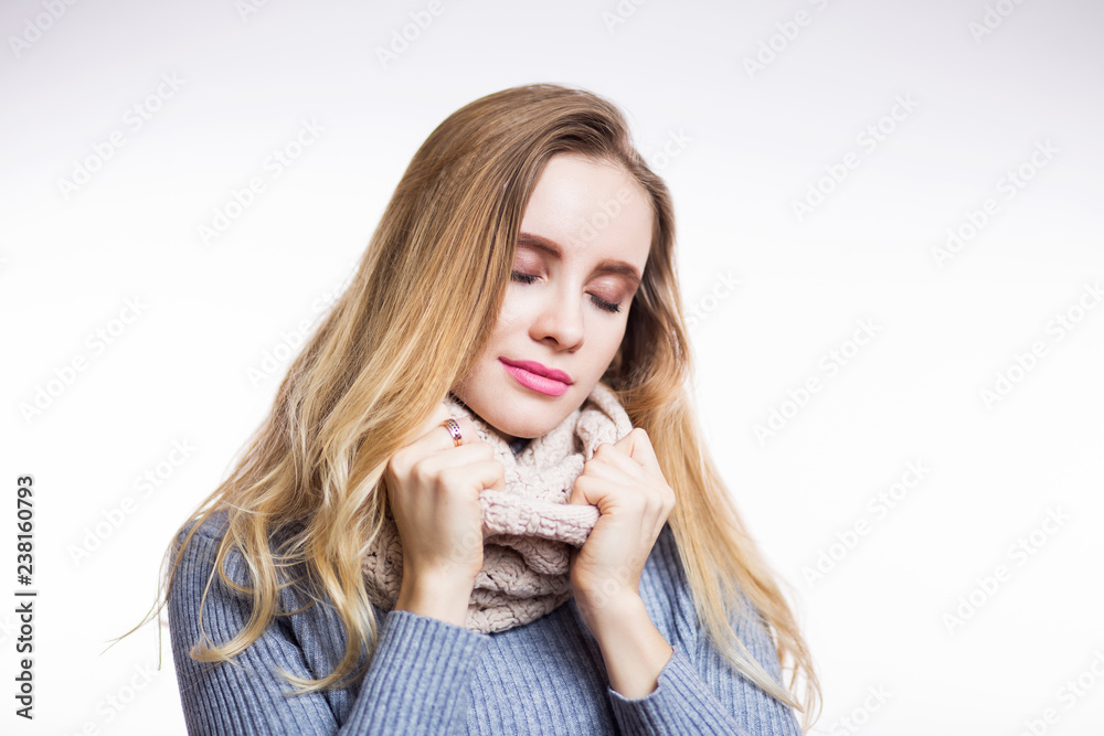 Winter portrait of young beautiful blonde woman wearing knitted snood. Christmas, cozy, fashion concept. Happy girl closes her eyes, dreams of a miracle, make a wish Winter portrait of young beautiful blonde woman wearing knitted snood. Christmas, cozy, fashion concept. Happy girl closes her eyes, dreams of a miracle, make a wish