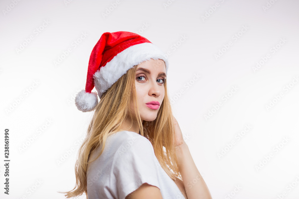 Christmas Santa woman in a red hat shows the kiss on a white background. Christmas, new year, Expressive facial expressions emotions