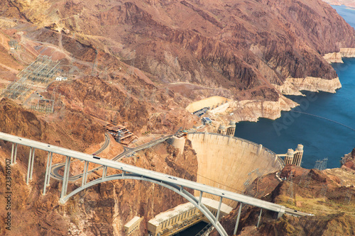 landscape and infrastructure and concept - aerial view of mike callaghan-pat tillman memorial bridge over colorado river and hoover dam at grand canyon from helicopter photo