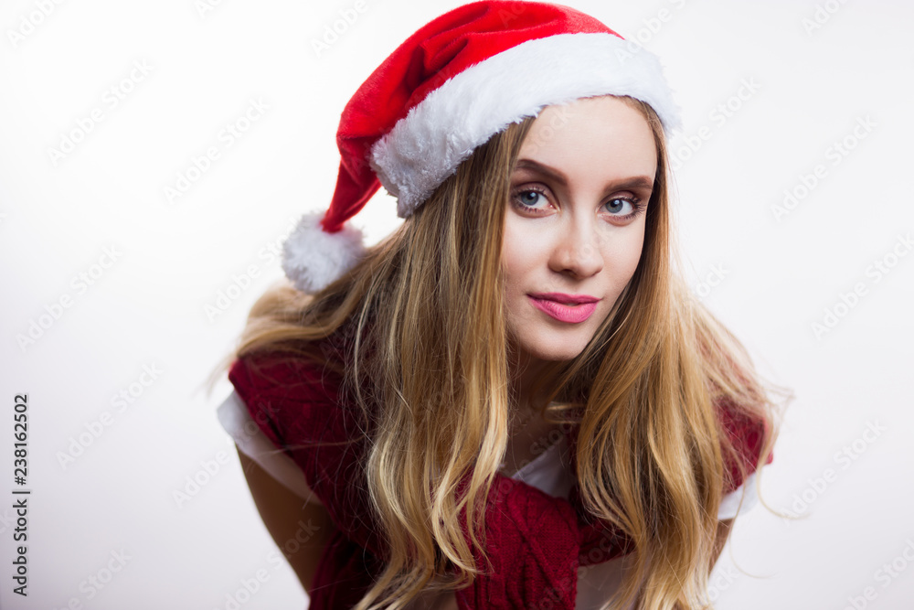 Beautiful smiling woman wear santa claus hat and leaned toward the camera to say something. Girl smiling, happy. Expressive facial expressions emotions Beautiful smiling woman wear santa claus hat and leaned toward the camera to say something. Girl smiling, happy. Expressive facial expressions emotions