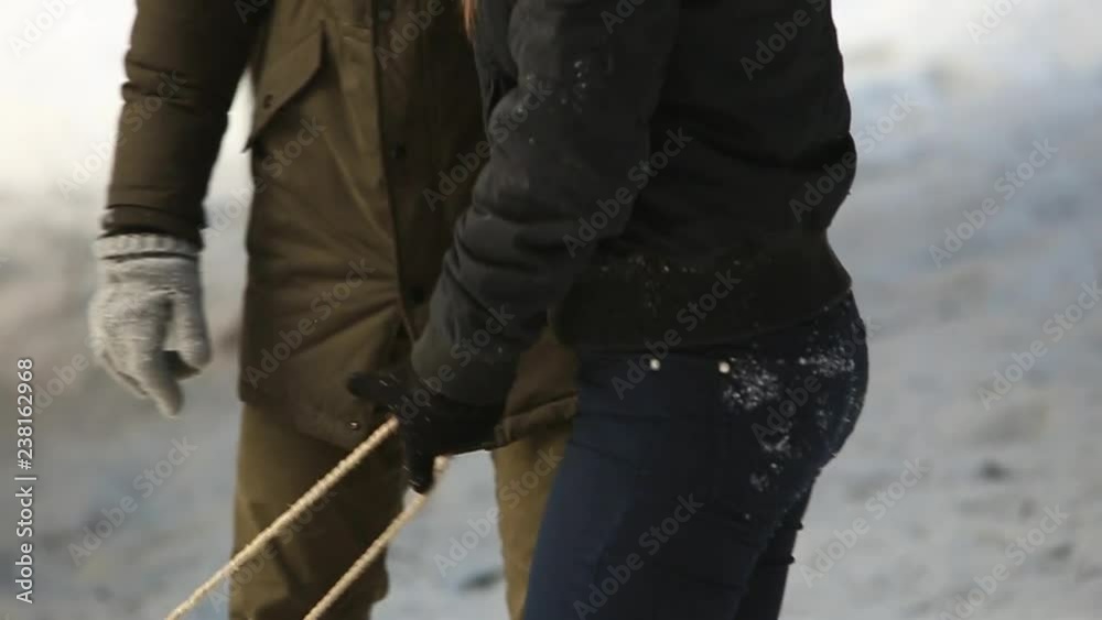 Boy and girl sledding. Snowy winter weather. Happy family. Christmas mood Boy and girl sledding. Snowy winter weather. Happy family. Christmas mood