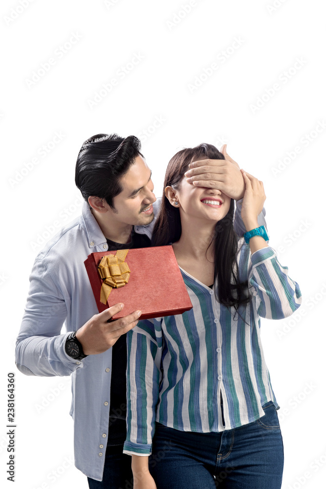 Young asian couple celebrating valentines day with giving a gift Young asian couple celebrating valentines day with giving a gift
