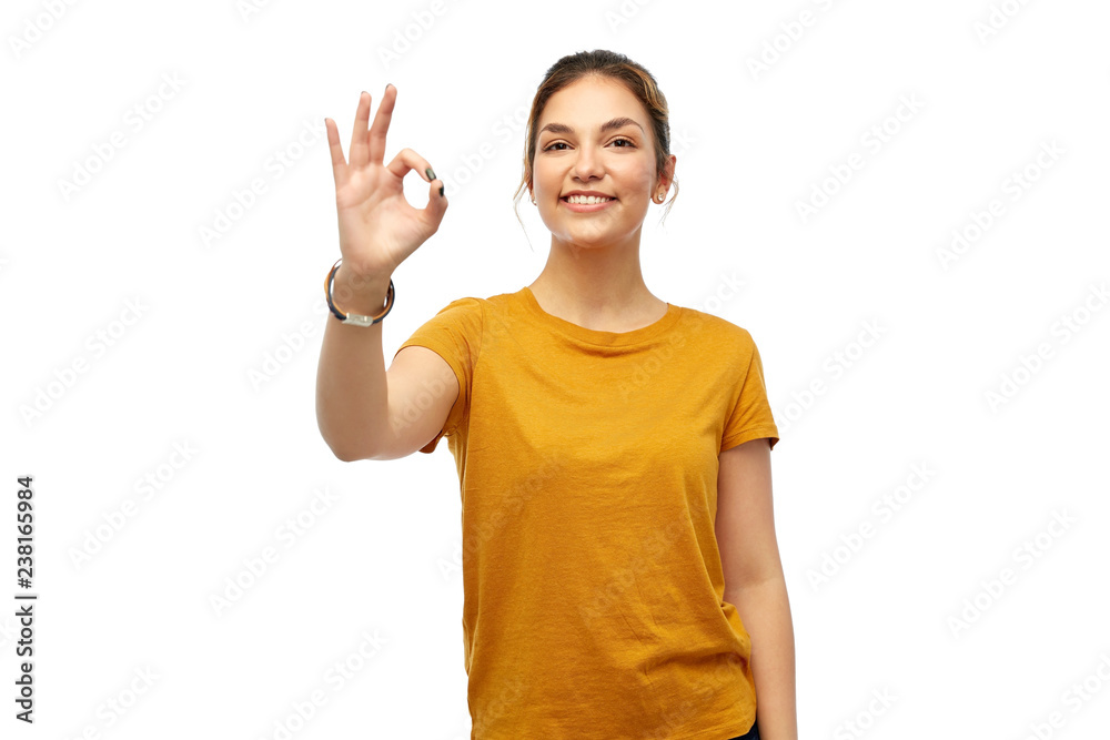 fashion, style and gesture concept - happy smiling young woman or teenage girl over white background showing ok hand sign fashion, style and gesture concept - happy smiling young woman or teenage girl over white background showing ok hand sign