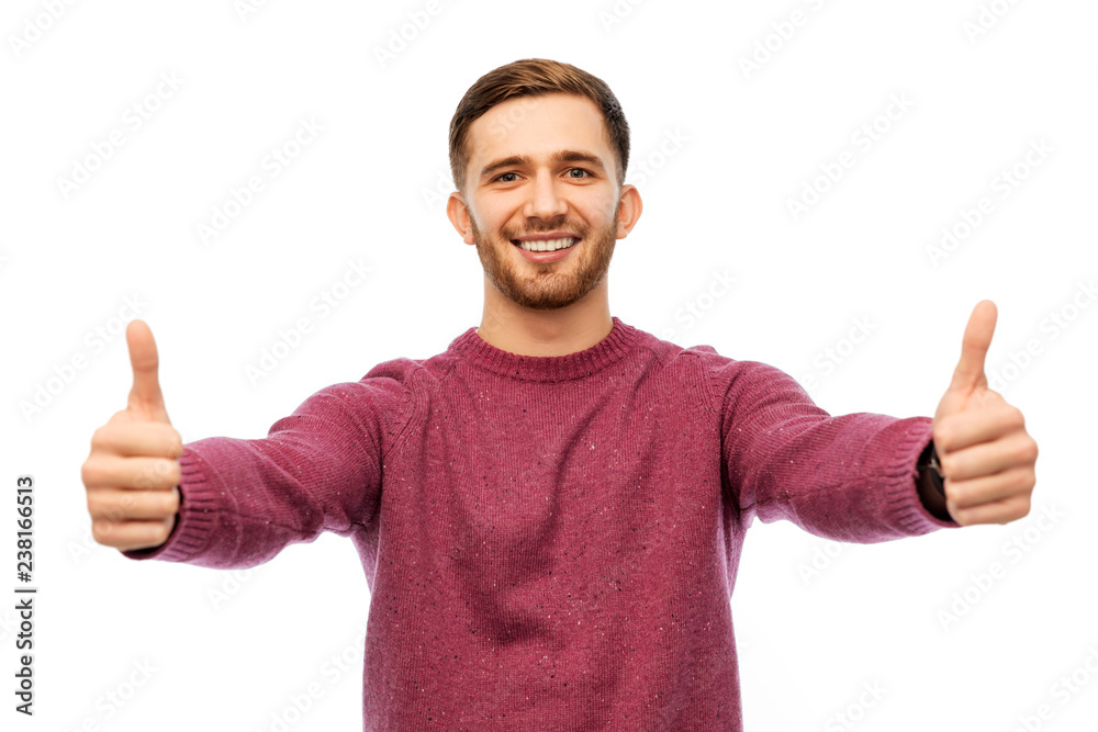 gesture and people concept - happy young man showing thumbs up over white background gesture and people concept - happy young man showing thumbs up over white background