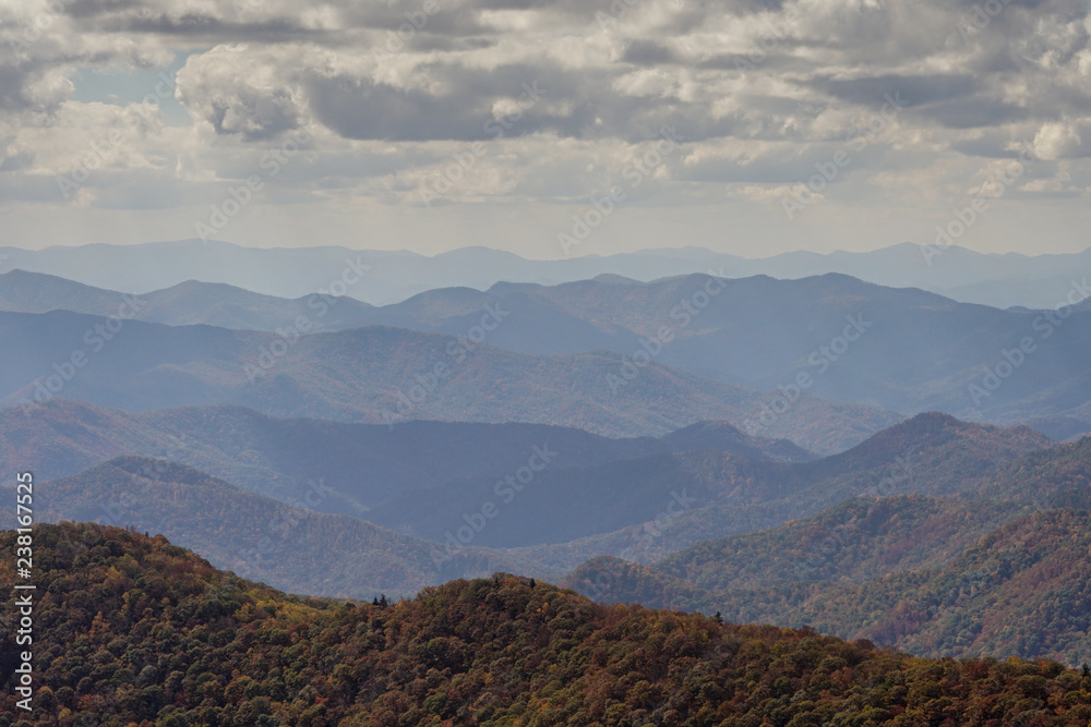 rolling mountain landscape with fall color foliage and forest and blue haze in the Blue Ridge mountains of North Carolina