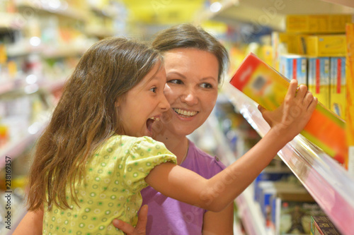 Portrait of mother and daughter choosing products photo