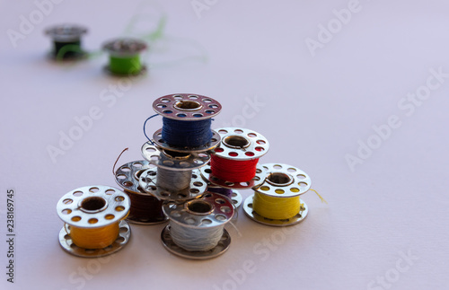 Stack of sewing machine bobbins with thread on them