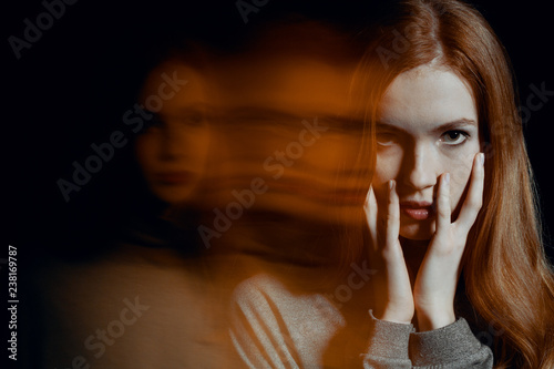 Fototapeta Naklejka Na Ścianę i Meble -  Scared beautiful young redhead woman with post traumatic stress disorder having sleep problems