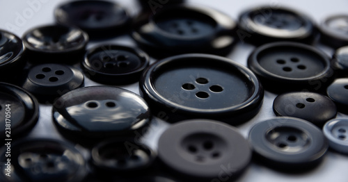 Closeup of assorted black and grey buttons